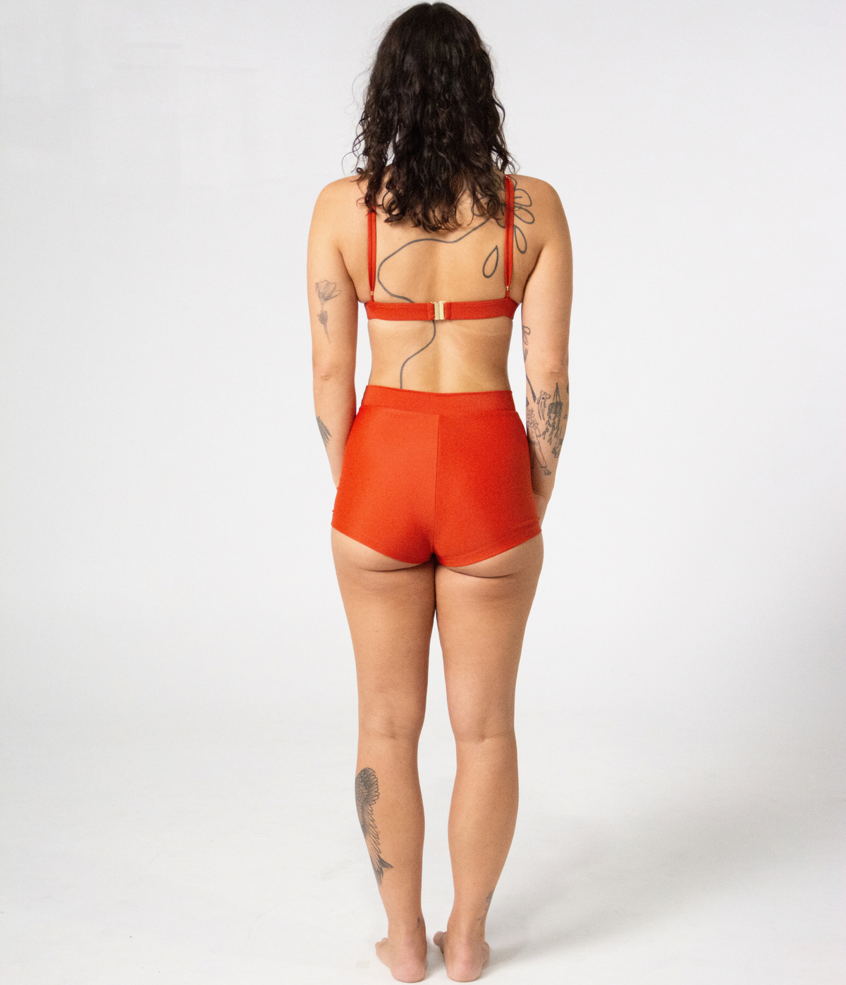 Burleigh Swim Shorts in Rust (orange), back view on model