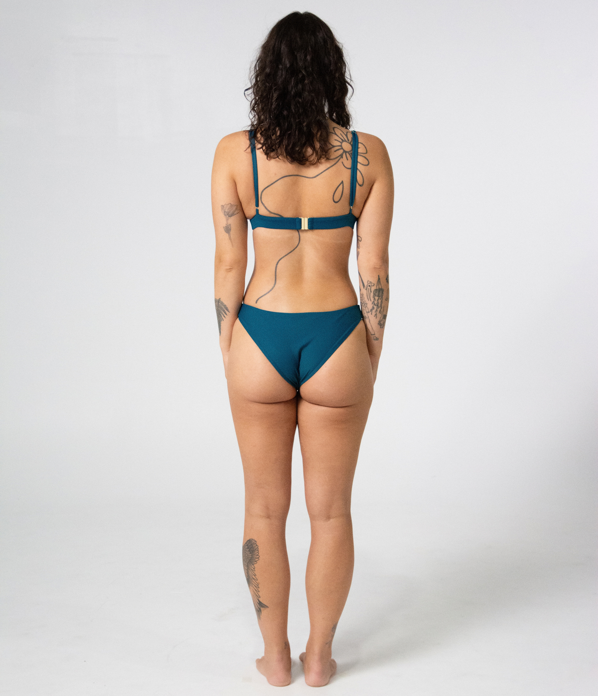 Kirra Triangle Top in Peacock (teal), back view on model showing the tie straps