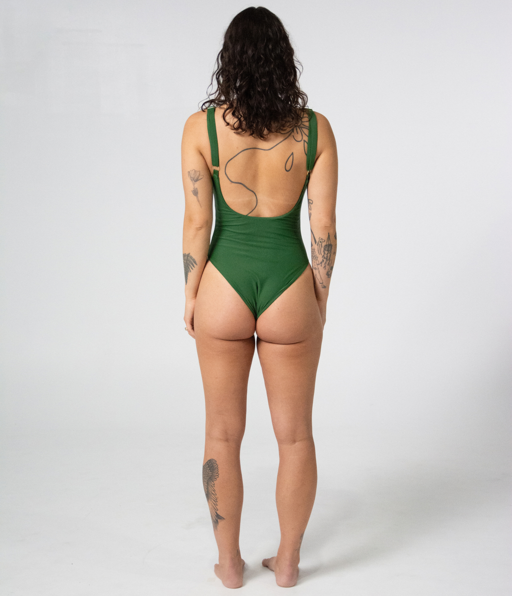 Mali One Piece in Fern (green), back view on model showing the scoop back and gold strap hardware