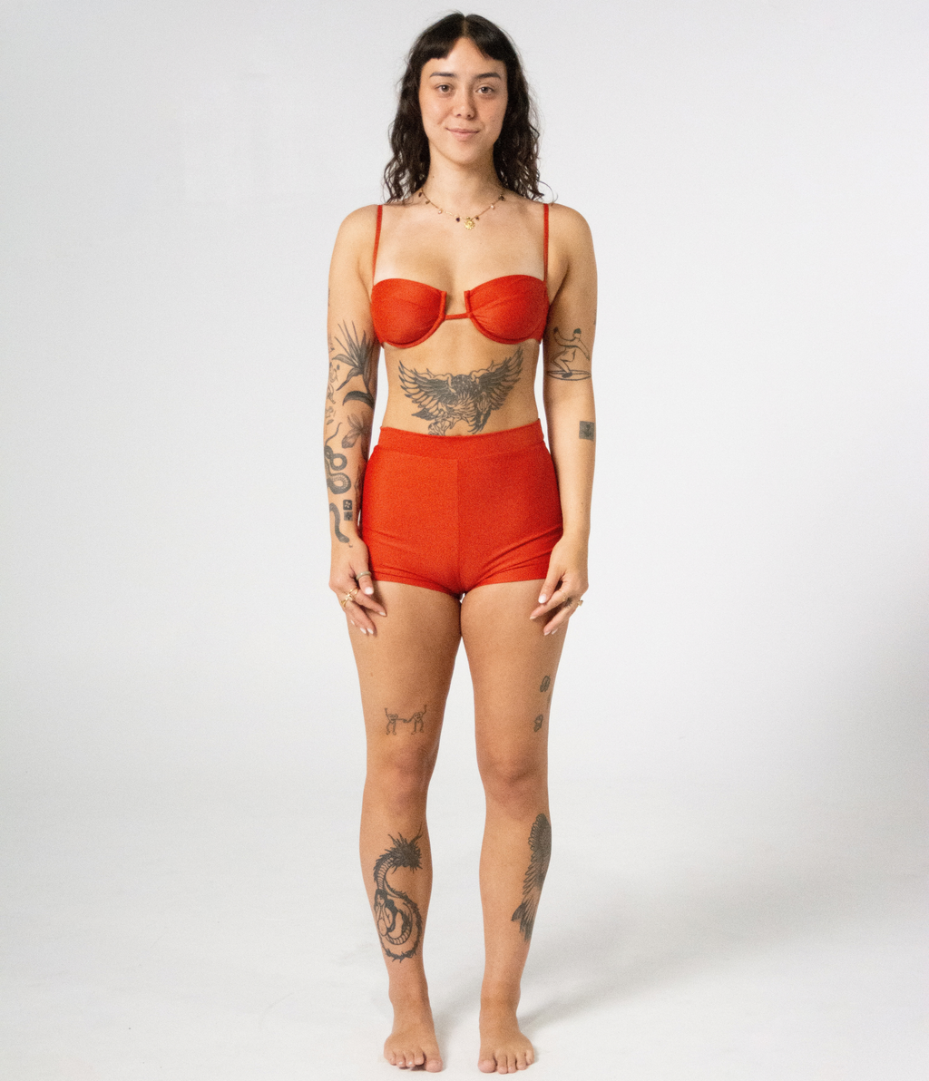 Burleigh Swim Shorts in Rust (orange), front view on model with hands on thighs