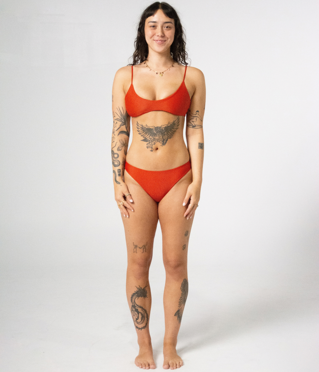 Crescent Scoop Top in Rust (orange), front view on model showing the scoop neckline