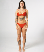 Crescent Scoop Top in Rust (orange), front view on model showing the scoop neckline