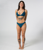 Kirra Triangle Top in Peacock (teal), front view on model with hands behind her back