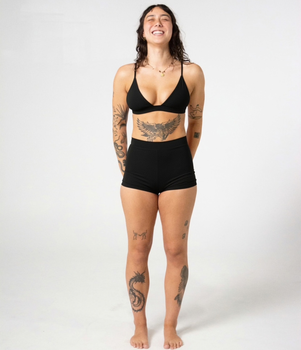 Kirra Triangle Top in Noir (black), front view on model with hands behind her back