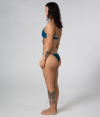 Crescent Scoop Top in Peacock (teal), left side view on model