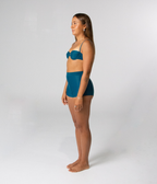 Wategos Underwire Top in Peacock (teal), left side view on model