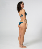 Crescent Scoop Top in Peacock (teal), right side view on model smiling