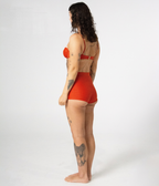 Burleigh Swim Shorts in Rust (orange), left side view on model showing the high waist