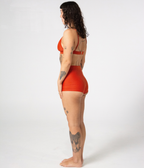 Kirra Triangle Top in Rust (orange), left side view on model