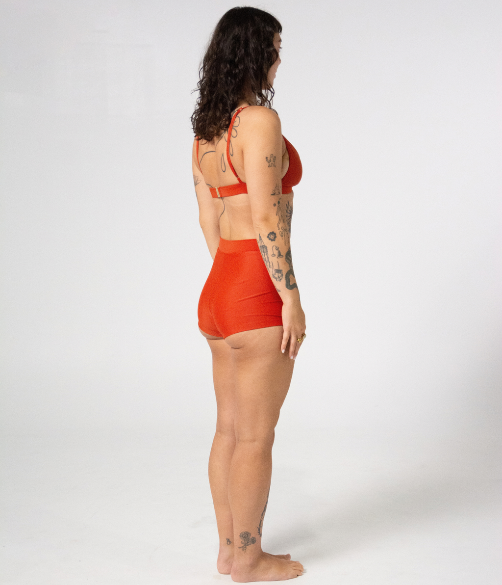 Burleigh Swim Shorts in Rust (orange), right side view on model showing the tailored cut